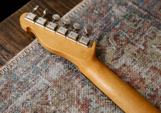 K-Line Truxton - Olympic White, NEW (Authorized Dealer) guitar headstock on patterned rug.