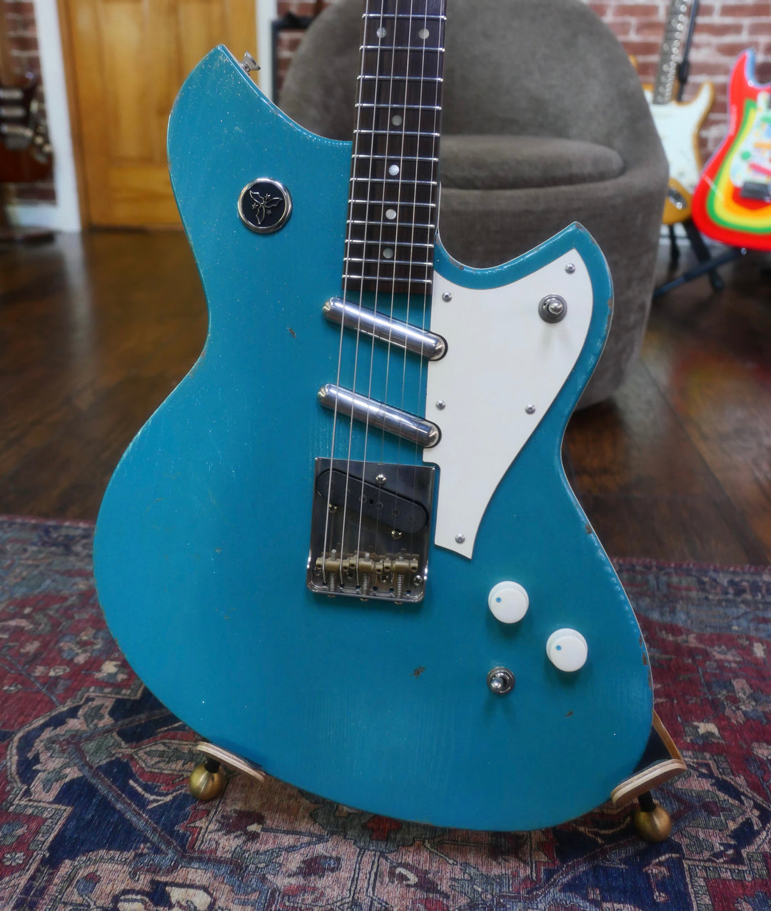 Novo Serus T Taos Turquoise guitar with a striking blue finish and classic white pickup cover.