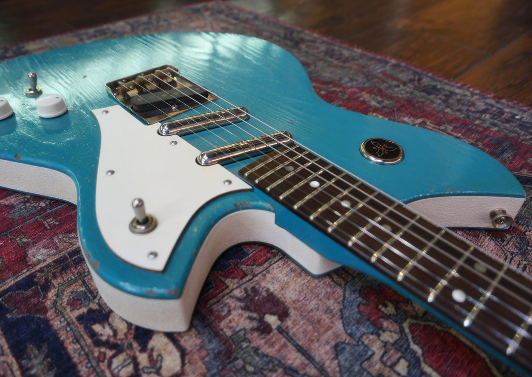 Novo Serus T Taos Turquoise guitar showcasing its unique design and craftsmanship by Dennis Fano.