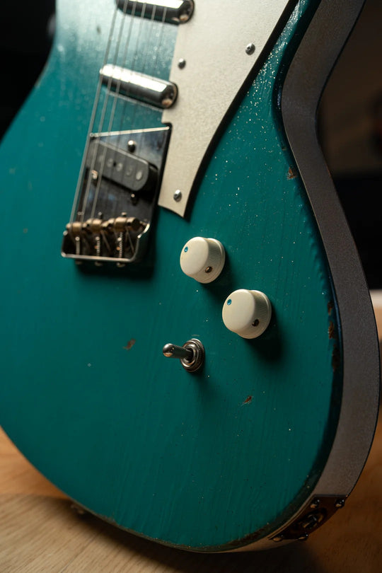 Close-up of the Novo Serus T Taos Turquoise guitar showcasing its striking finish and unique controls.